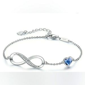 CDE INFINITI HEART AUSTRALIAN BLUE CRYSTAL GOLD PLATED BRACELET.